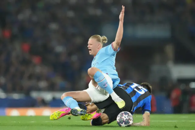 Erling Haaland tackled by Francesco Acerbi