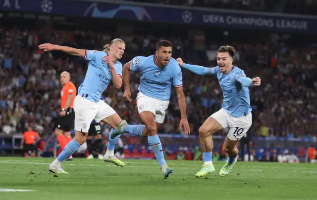 Rodri (centre) celebrates scoring