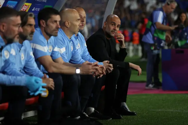 Pep Guardiola (right) on the Man City bench