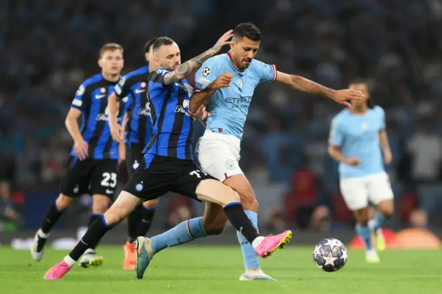 Rodri holds off a challenge from Marcelo Brozovic