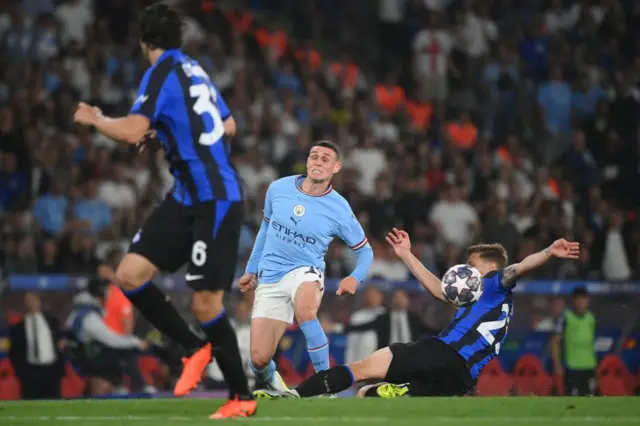 Phil Foden (centre) is tackled