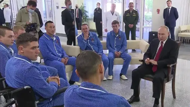 Russian President Putin speaks to servicemen in a hospital