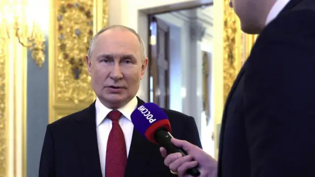 Vladimir Putin speaks to a reporter