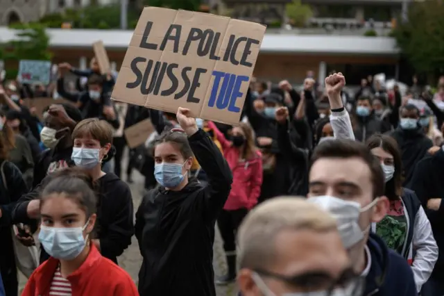 People take part in a rally on June 13, 2020 in Lausanne against racism and police brutality