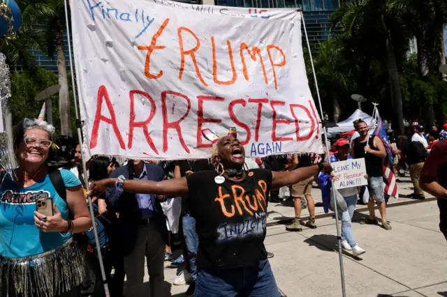 Protestors gather outside a Miami courthouse on Tuesday