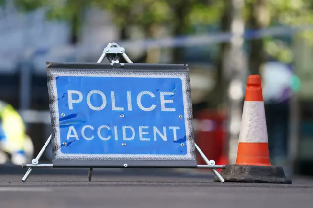 A 'police accident' sign on the road