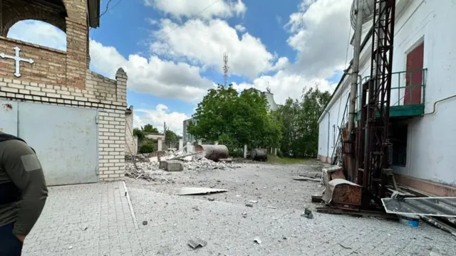 A church courtyard with debris across it