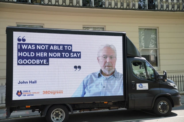 A billboard reading "I was not able to hold her, nor to say goodbye"