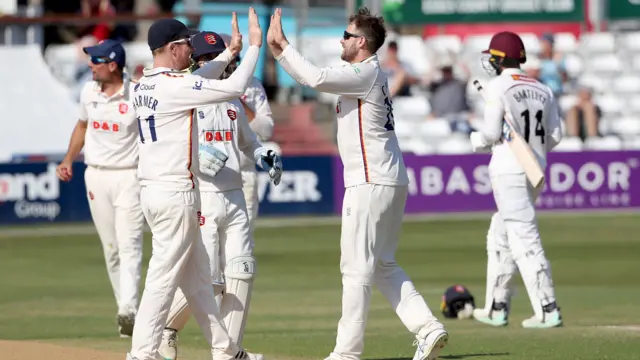 Matt Critchley of Essex celebrates with his team mates after taking the wicket of George Bartlett