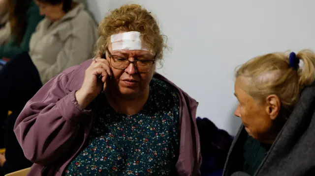 People react at a site of a residential building heavily damaged by a Russian missile strike, amid Russia's attack on Ukraine, in Kryvyi Rih