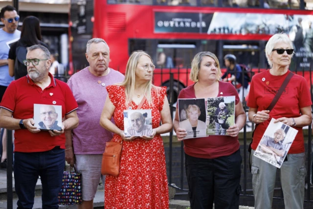 A group of campaigners holding pictures