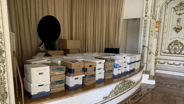 Boxes of documents stored on the stage of the White and Gold Ballroom at Trump's Mar-a-Lago club in Florida