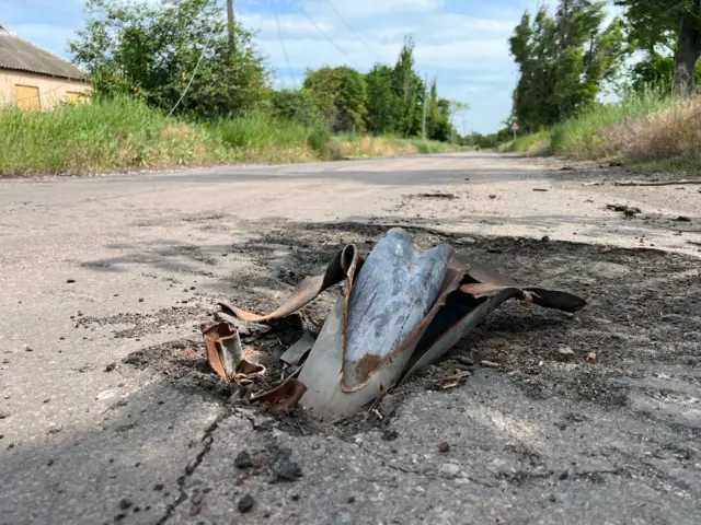 The remains of a rocket implanted in a road