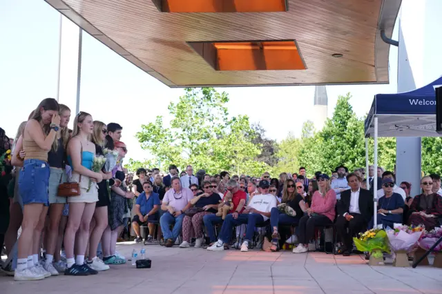 The families of Grace Kumar and Barnaby Webber (seated front) attend a vigil at the University of Nottingham