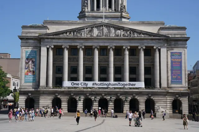 A banner is placed on the outside of City Council buildings in Market Square, Nottingham