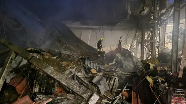 Firefighter on rubble heap