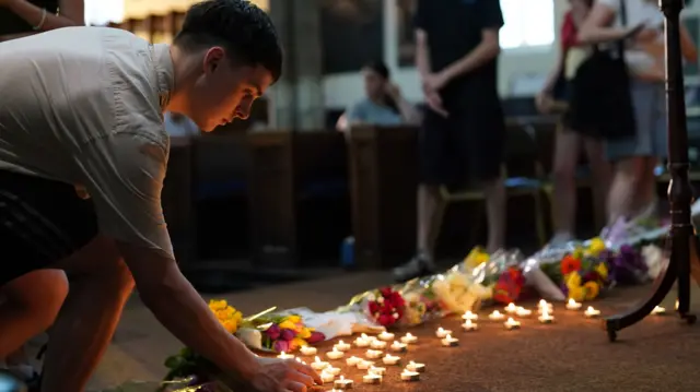 Young man lighting a candle