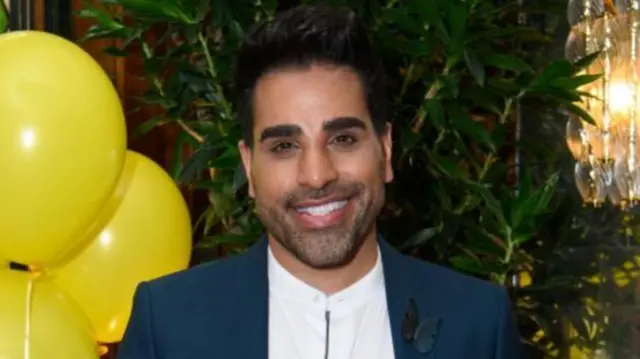 Dr Ranj stands in suit