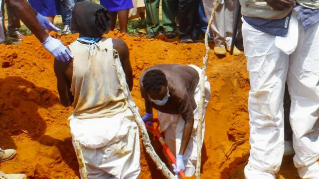 Volunteers exhume bodies of suspected followers of a Christian cult named as Good News International Church, whose members believed they would go to heaven if they starved themselves to death, in Shakahola forest of Kilifi county, Kenya April 25