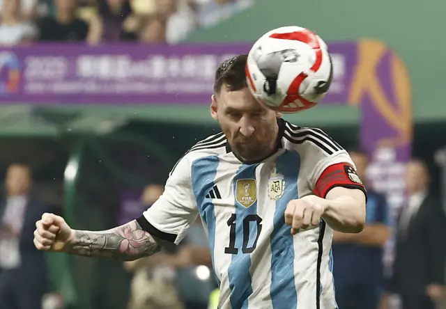 Lionel Messi heads the ball in Beijing