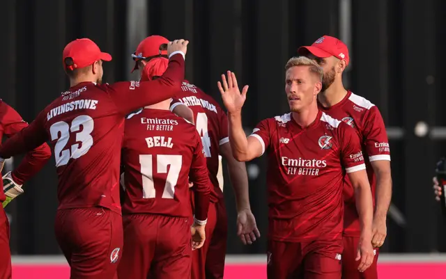 Luke Wood celebrates a wicket with his Lancahire team-mates