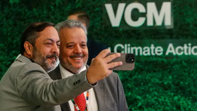 arrukh Ikram of Saudi Arabian Mining Company (Ma'aden) takes a selfie with Fahad Al-Shrehhy of Saudi Basic Industries Corporation (Sabic), ahead of the voluntary auction of carbon credits, with projects in Kenya, Rwanda, Egypt and South Africa, at the auction in Nairobi, Kenya - 14 June 2023