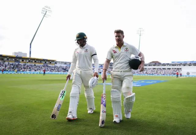 Usman Khawaja and David Warner walking off at the end of play