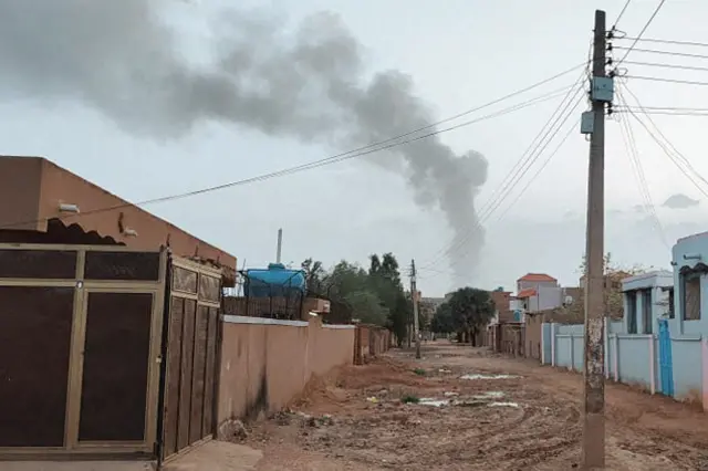 Smoke billows in the distance amid ongoing fighting in Khartoum on June 13, 2023.