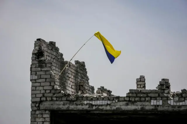 A Ukrainian national flag is seen, amid Russia's attack on Ukraine, near the front line in the newly liberated village Neskuchne in Donetsk region, Ukraine June 13, 2023.