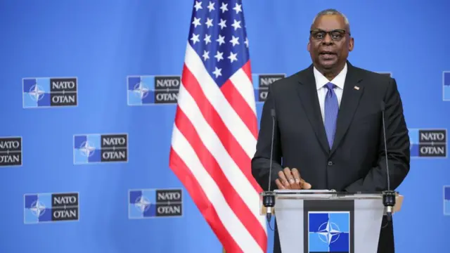 Lloyd Austin addressing a gathering of his Nato counterparts in Brussels