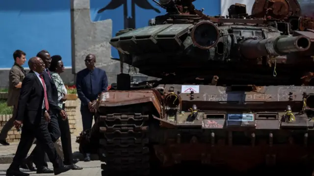 African leaders walk by a destroyed tank in Kyiv