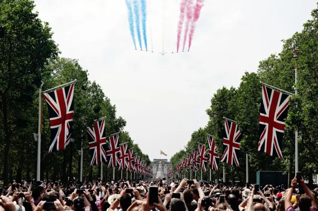 Crowds on The Mall watch the flypast