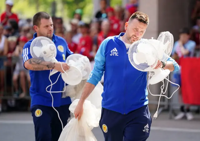 Scotland staff carrying fans