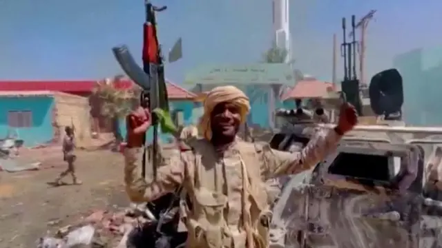 A member of the RSF walks around the destroyed Air Defence Forces command site in Khartoum, Sudan, in this screengrab obtained from a social media video on June 14, 2023