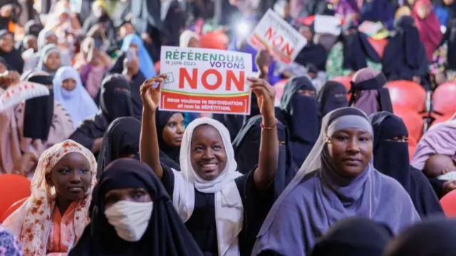 A woman holds up a sign  during a march against the new constitution organised by the Association of Imams, in Bamako -16  June 2023