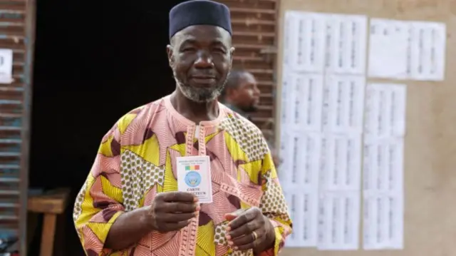 A voter holds up his voting card during Mali's referendum in Bamako - 18 June 2023