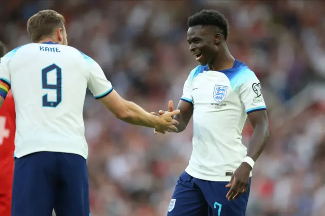 Bukayo Saka celebrates with Harry Kane after scoring in England's Euro 2024 qualifier against North Macedonia at Old Trafford