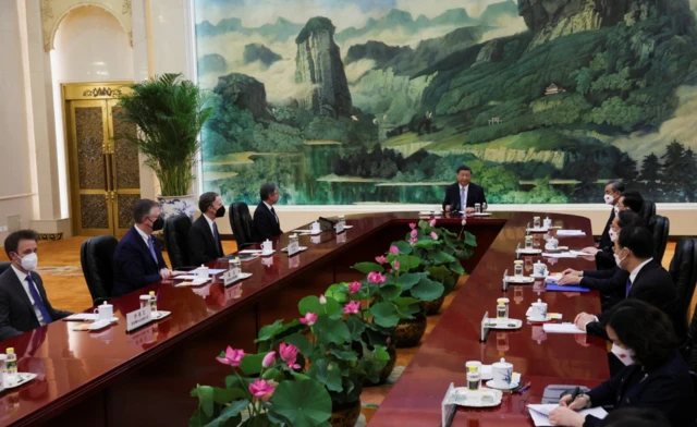 Xi and Blinken and others sit around the meeting table in the Great Hall of the People