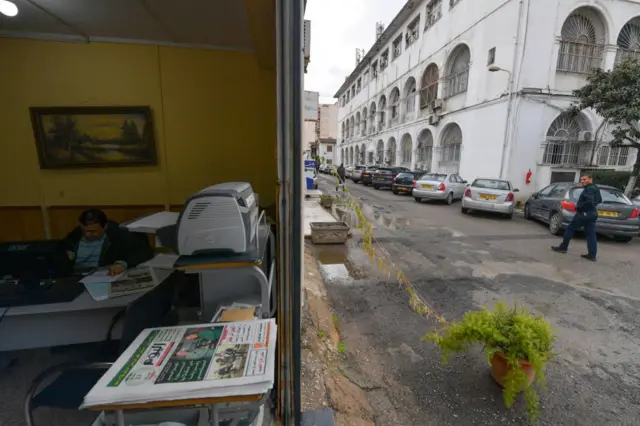 A journalist sits behind his desk at the Arabic-speaking daily "El Youm" newspaper at the Tahar Djaout press house in Algiers on January 18, 2023.