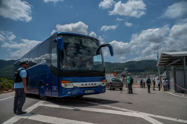 A bus with survivors of a shipwreck enters a migrant camp in Malakasa, near Athens on June 16, 2023, after a boat carrying dozens of migrants sank in international waters in the Ionian Sea