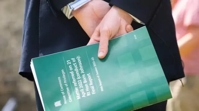 Jacob Rees-Mogg holds a copy of the committee's report