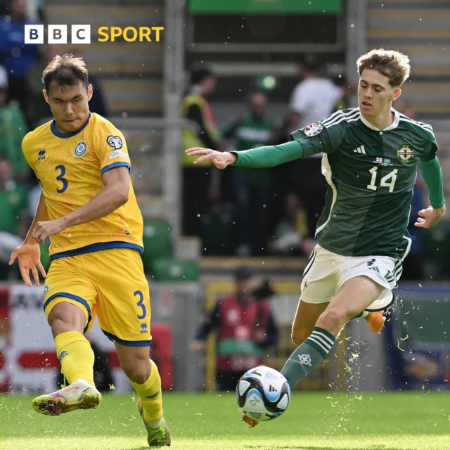 Isaac Price of Northern Ireland runs with the ball whilst under pressure from Nuraly Alip of Kazakhstan