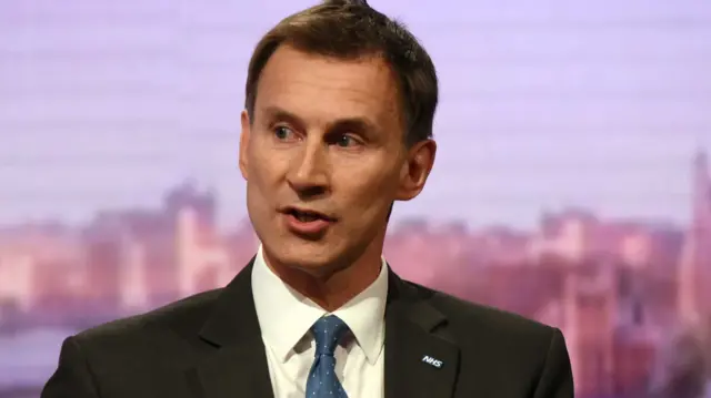 Jeremy Hunt with an NHS badge on