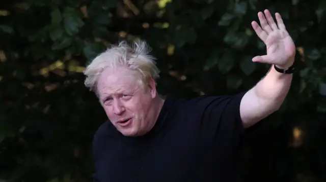 Former British Prime Minister Boris Johnson gestures as he runs near his home