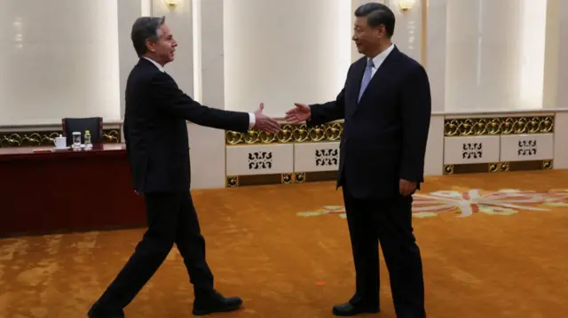 Blinken moves to shake hands with Xi