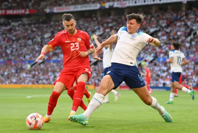 Harry Maguire closes down an opponent during England's Euro 2024 qualifier against North Macedonia at Old Trafford