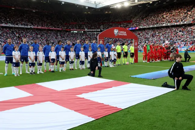 England and North Macedonia stand for the national anthems ahead of the teams' Euro 2024 qualifier at Old Trafford