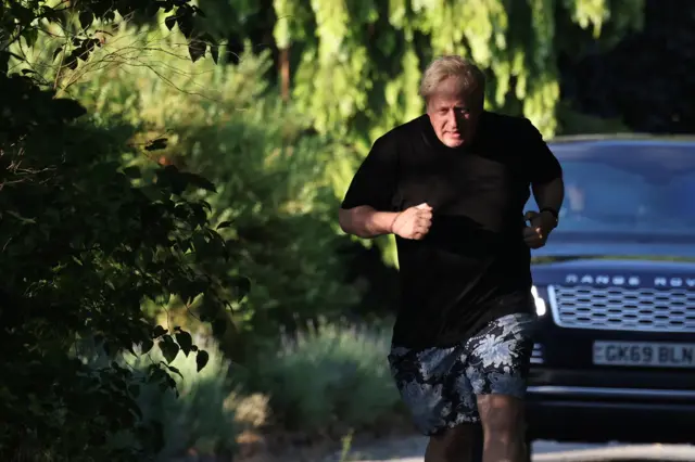 Former British Prime Minister Boris Johnson runs near his home