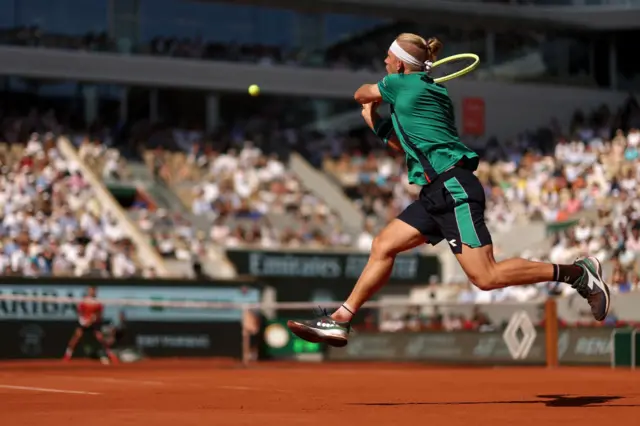 Alejandro Davidovich Fokina jumps to play a backhand shot