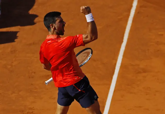 Novak Djokovic punches the air in celebration
